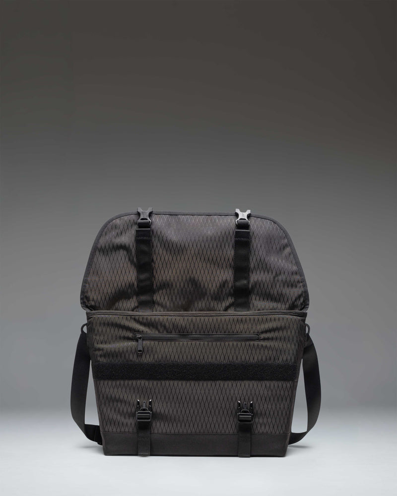 Herschel Supply Co. Cove Messenger bag in Black Diamond/Black, showing the lifestyle view of the bag being worn.