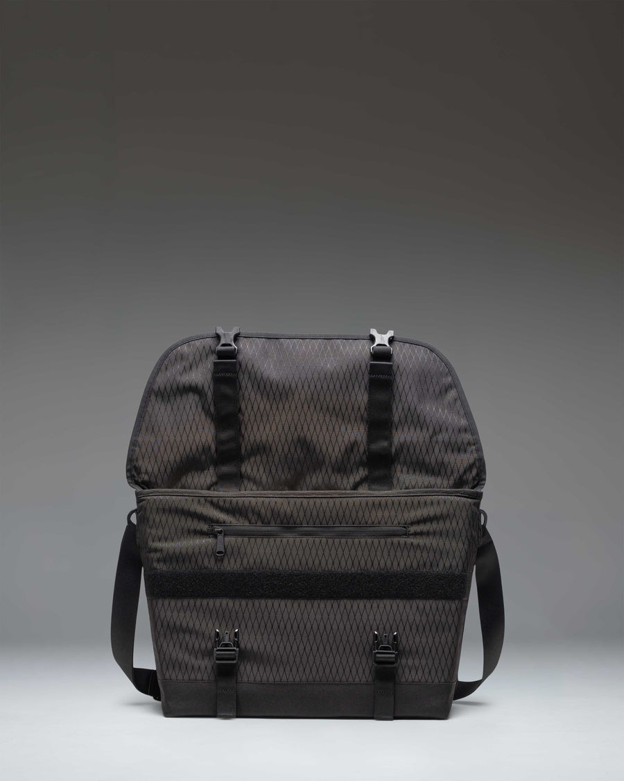 Herschel Supply Co. Cove Messenger bag in Black Diamond/Black, showing the lifestyle view of the bag being worn.