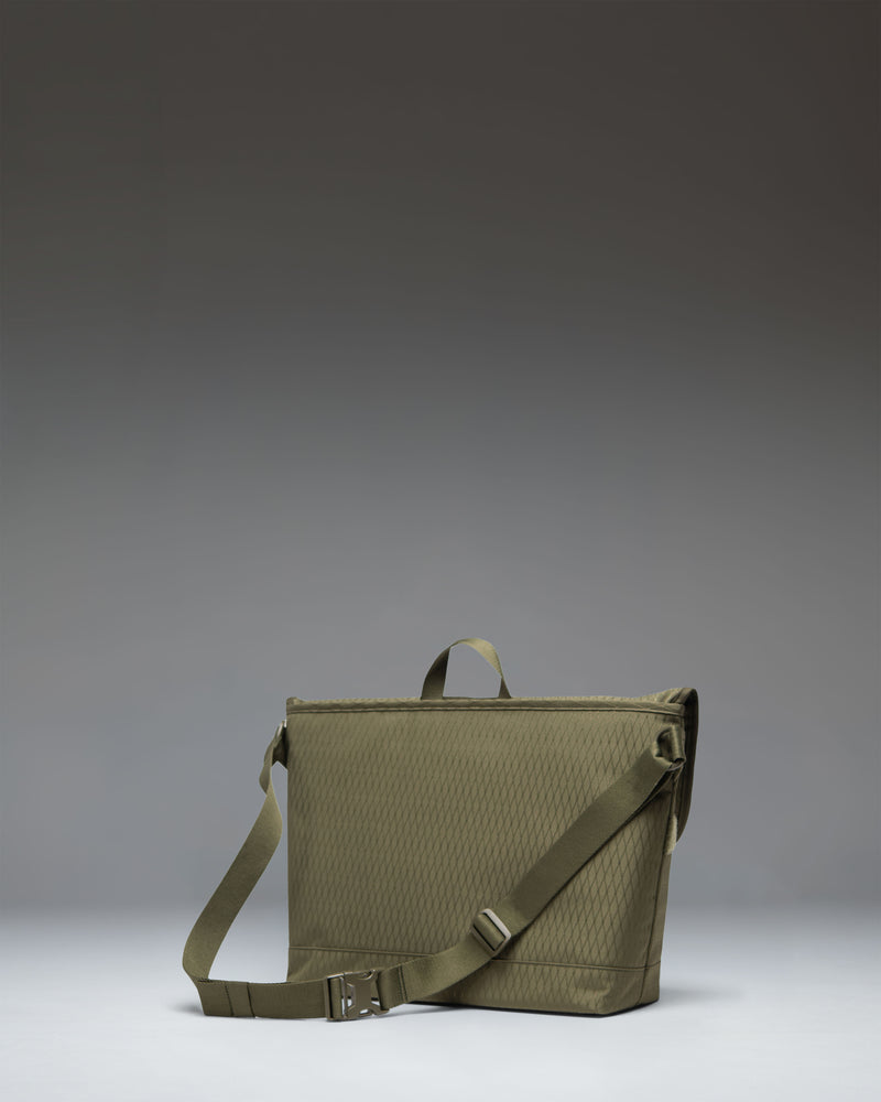Herschel Supply Co. Cove Messenger bag in Ivy Green Diamond, showing a front view of the structured messenger design with strap details.