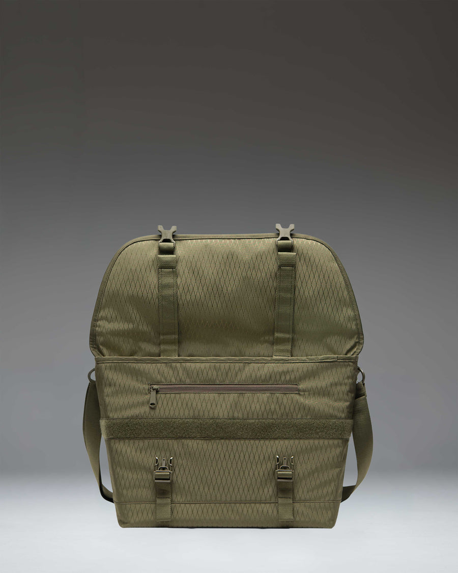 Herschel Supply Co. Cove Messenger bag in Ivy Green Diamond, showing a lifestyle view of the bag being worn.