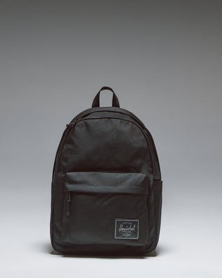 Herschel Classic Backpack in Black Tonal, shown from the front with a clean, minimalist design and front pocket.