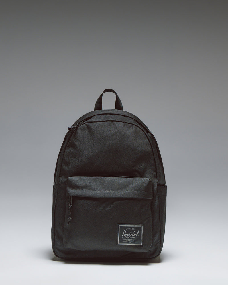 Herschel Classic Backpack in Black Tonal, shown from the front with a clean, minimalist design and front pocket.