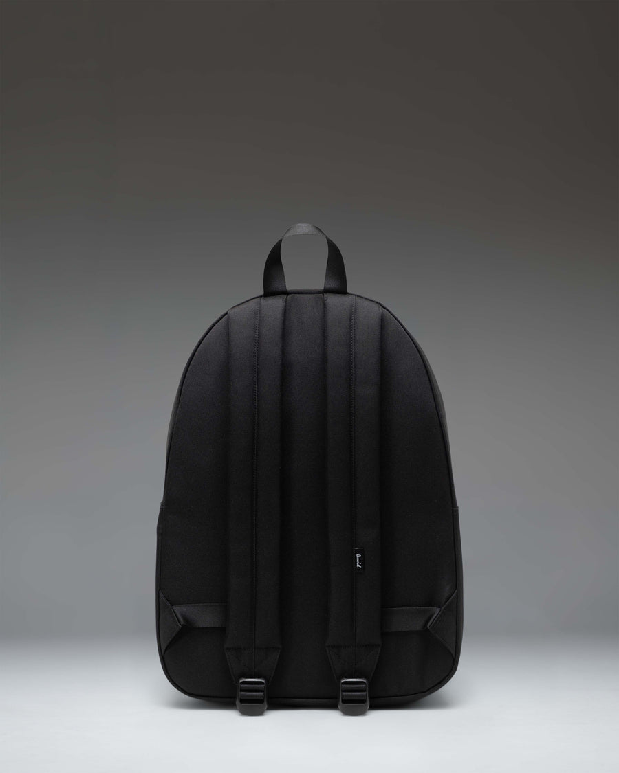 Herschel Classic Backpack in Black Tonal featuring a minimalist design, front zipper pocket, and the signature woven label.