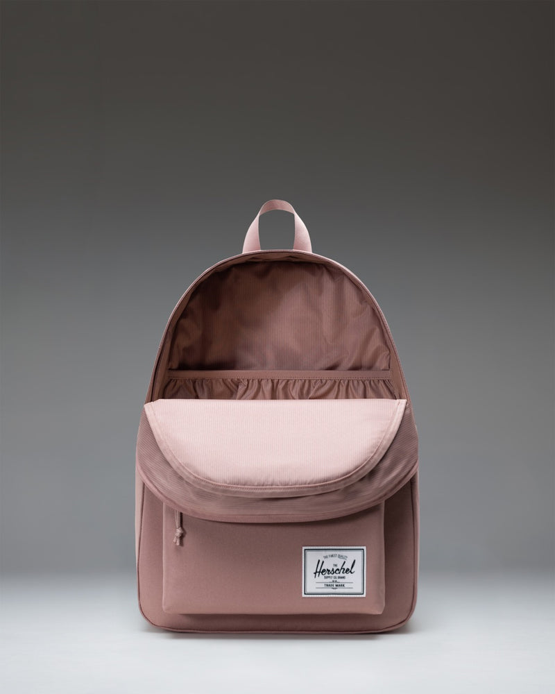 Herschel Classic XL Backpack in Ash Rose, a dusty pink color, featuring a front zippered pocket and a top handle.