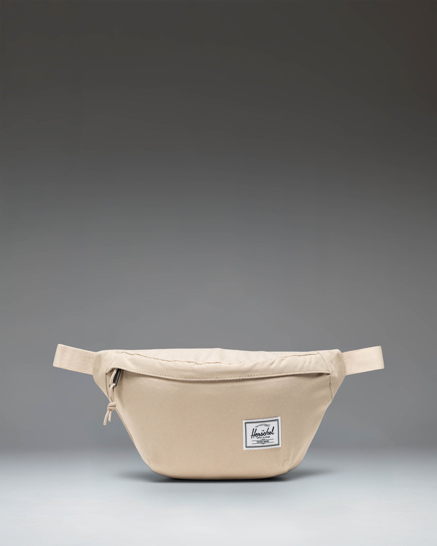 Herschel Classic Hip Pack in Eucalyptus green, showing a compact waist bag with an adjustable strap and front zipper pocket.