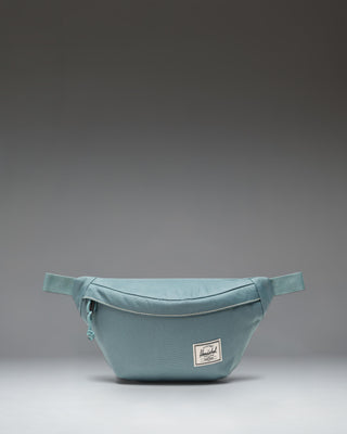 Herschel Classic Hip Pack, a compact 1L waist pack featuring a zippered main closure with a Prusik cord pull and an adjustable webbing strap.