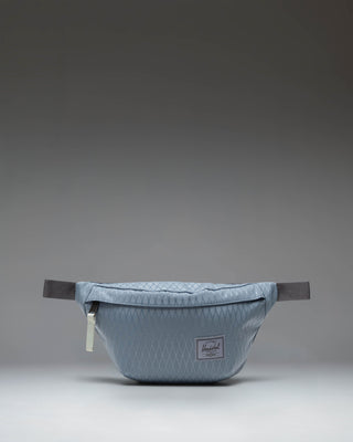 Herschel Classic Hip Pack in Blue Mirage Diamond and Sea Storm colorway, showing the front view with zipper closure and adjustable strap.