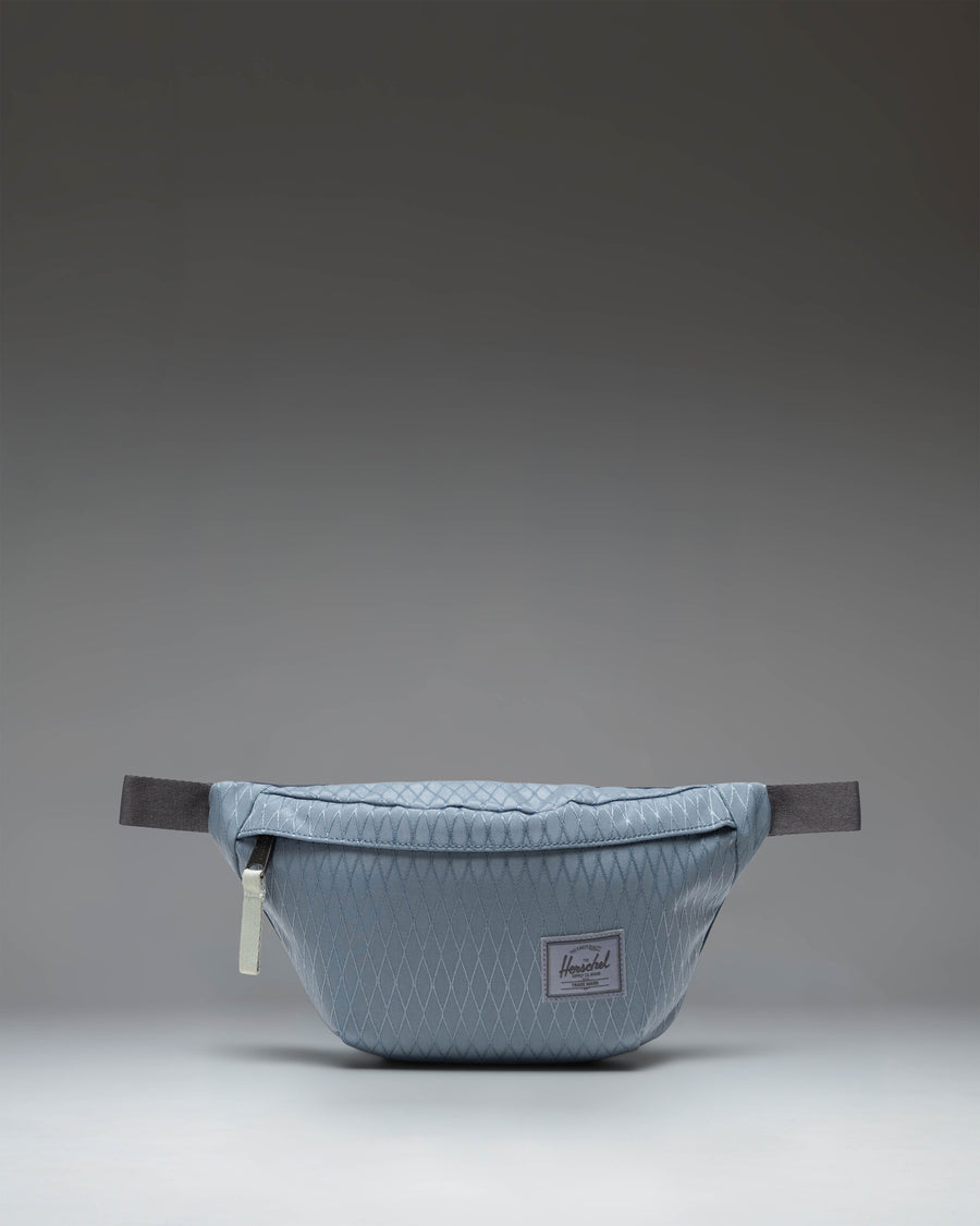 Herschel Classic Hip Pack in Blue Mirage Diamond and Sea Storm colorway, showing the front view with zipper closure and adjustable strap.