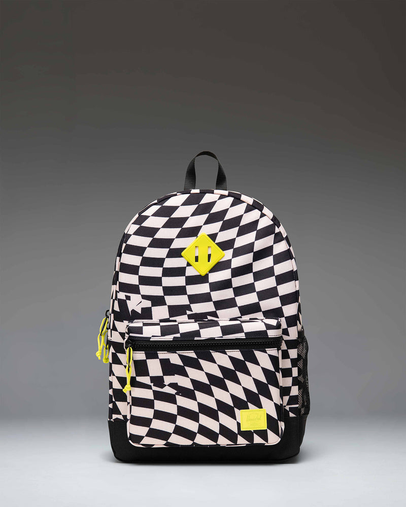 Herschel Heritage Youth Backpack in the checkered Warp Check pattern, featuring a front storage pocket and classic silhouette.