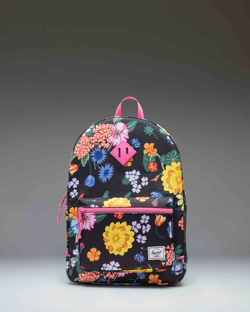 Herschel Supply Co. Herschel Heritage Youth Backpack in the Paper Garden floral print pattern, featuring a front pocket and classic diamond accent.