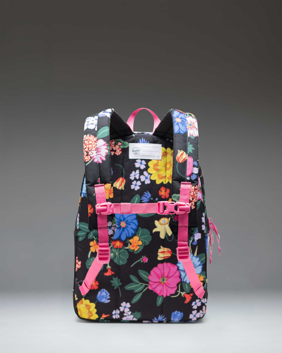Herschel Heritage Youth Backpack in Paper Garden floral print featuring pink flowers and green leaves on a black background.