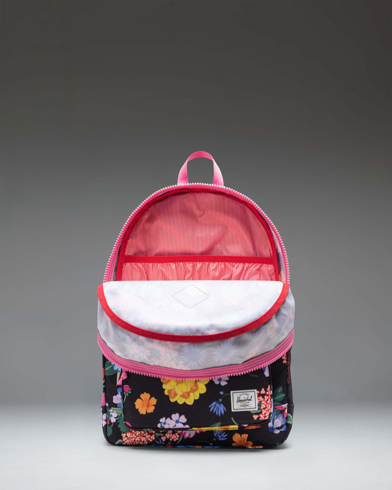 Herschel Heritage Youth Backpack in Paper Garden floral print, featuring a front pocket, rubber diamond accent, and a classic silhouette.