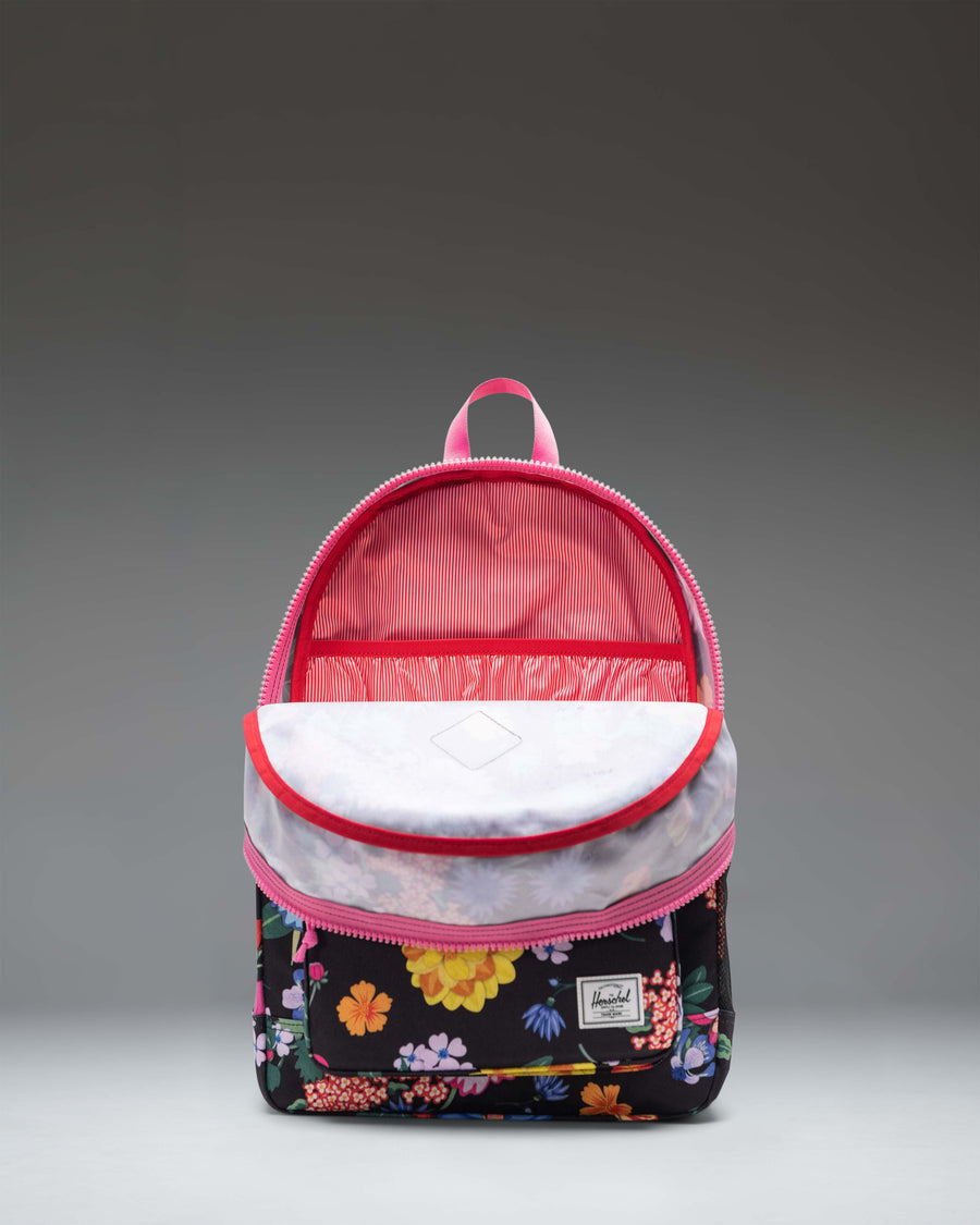 Herschel Heritage Youth Backpack in Paper Garden floral print, featuring a front pocket, rubber diamond accent, and a classic silhouette.