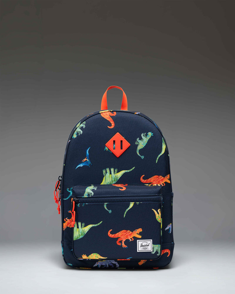 Herschel Heritage Youth Backpack in Water Colour Dinosaurs Darkest Navy, featuring a colorful dinosaur pattern on a dark blue background.
