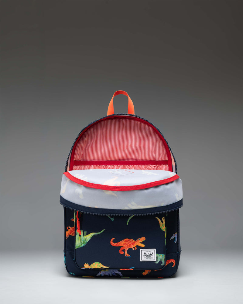 Herschel Heritage Youth Backpack in Water Colour Dinosaurs Darkest Navy, featuring a colorful dinosaur pattern on a dark navy blue background.