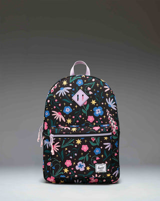 Herschel Heritage Youth Backpack in Enchanted Garden, featuring a vibrant floral pattern on a dark background with a front pocket.