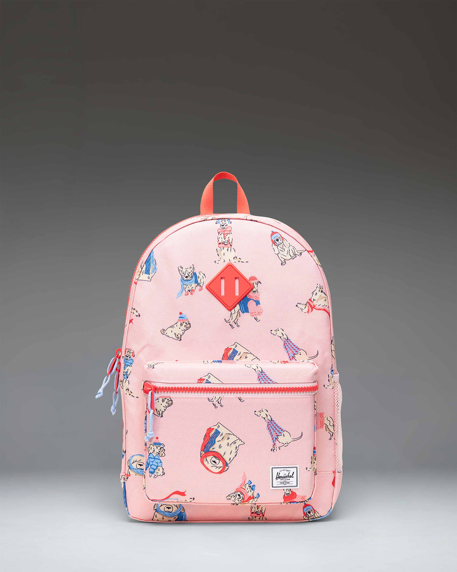 Herschel Heritage Youth Backpack in Fashion Dogs pattern, featuring a playful canine print on a light blue background.