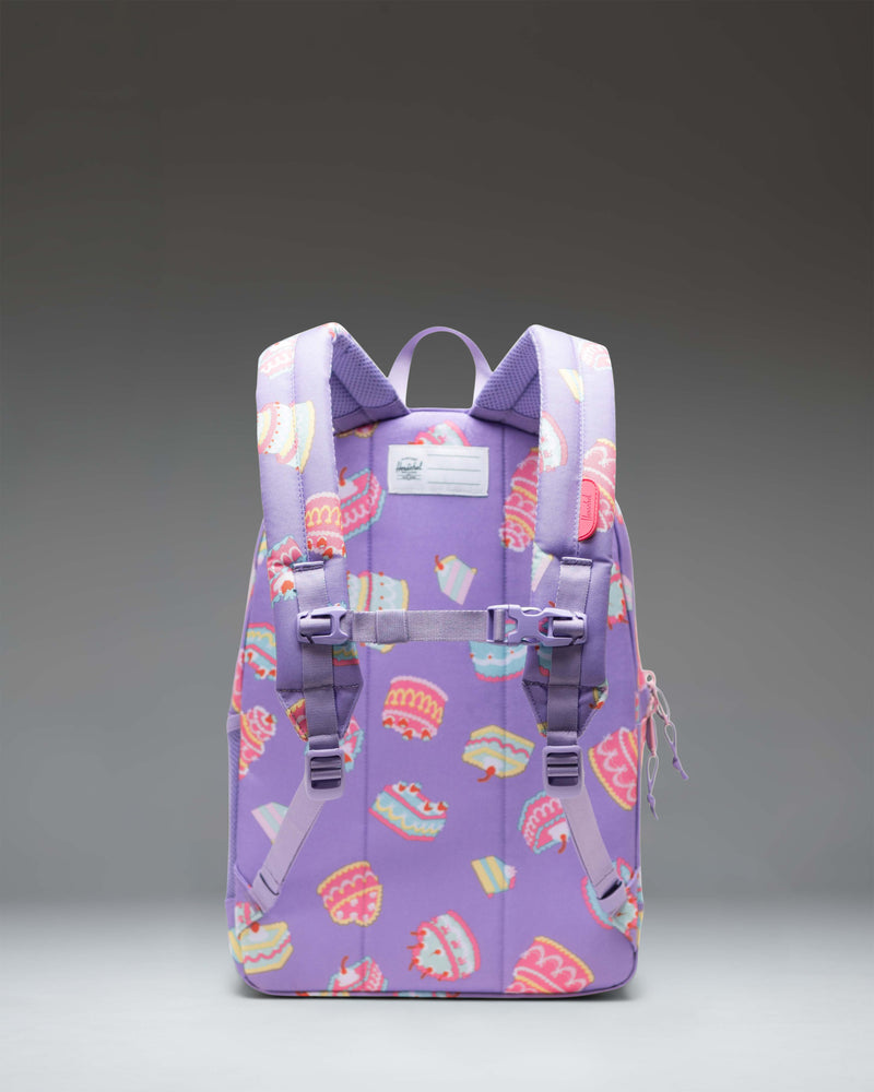 Herschel Heritage Youth Backpack in a playful cake print design featuring pink frosting and colorful sprinkles.