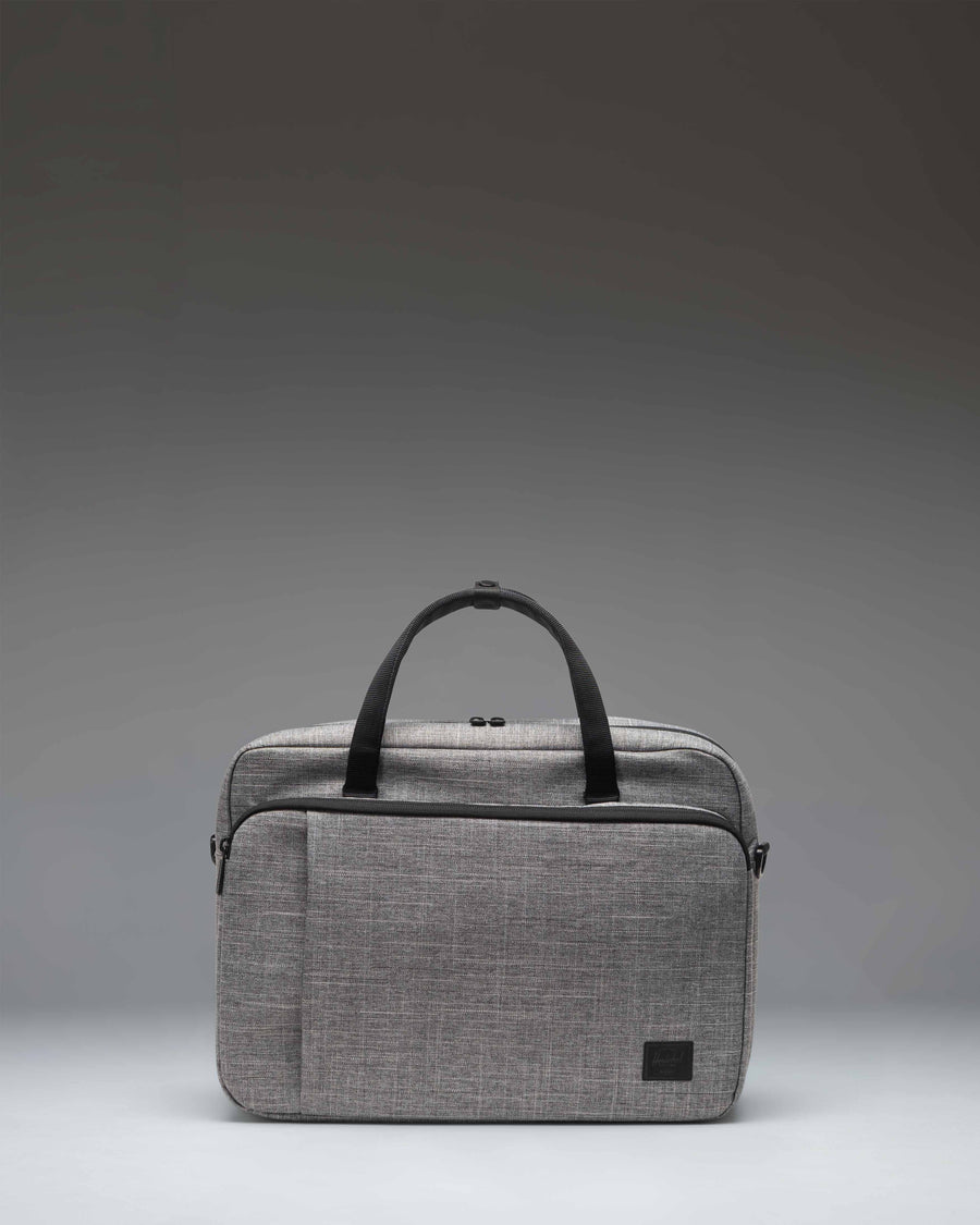 Herschel Supply Co. Gibson Messenger Tech bag in Raven Crosshatch grey, showing a front view with dual top handles and a zippered pocket.