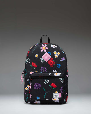 Herschel Supply Co. LEGO Heritage Youth Backpack in Falling Florals print, showing the front pocket with LEGO brick-inspired details.