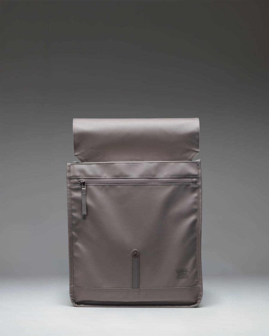 Herschel Supply Co. City Backpack in Dark Gull Gray shown from the front, highlighting its clean design, single strap closure, and front pocket.