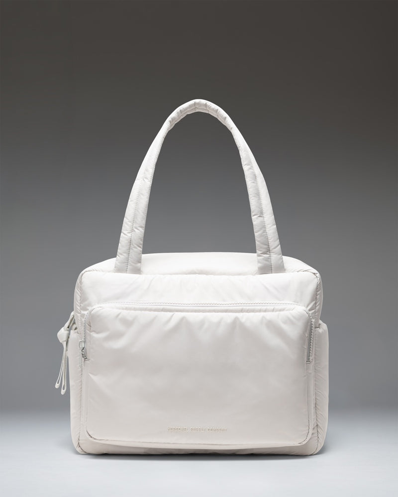 Herschel Supply Co. Cloudform Duffle Bag in Metal colorway. Lightweight, minimalist design with padded fabric, dual top handles, and logo detail.