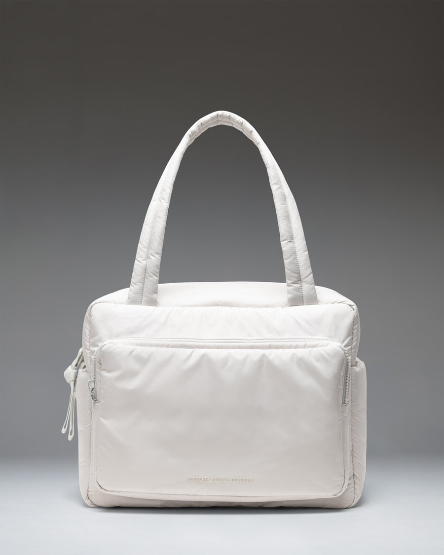 Herschel Supply Co. Cloudform Duffle Bag in Metal colorway. Lightweight, minimalist design with padded fabric, dual top handles, and logo detail.