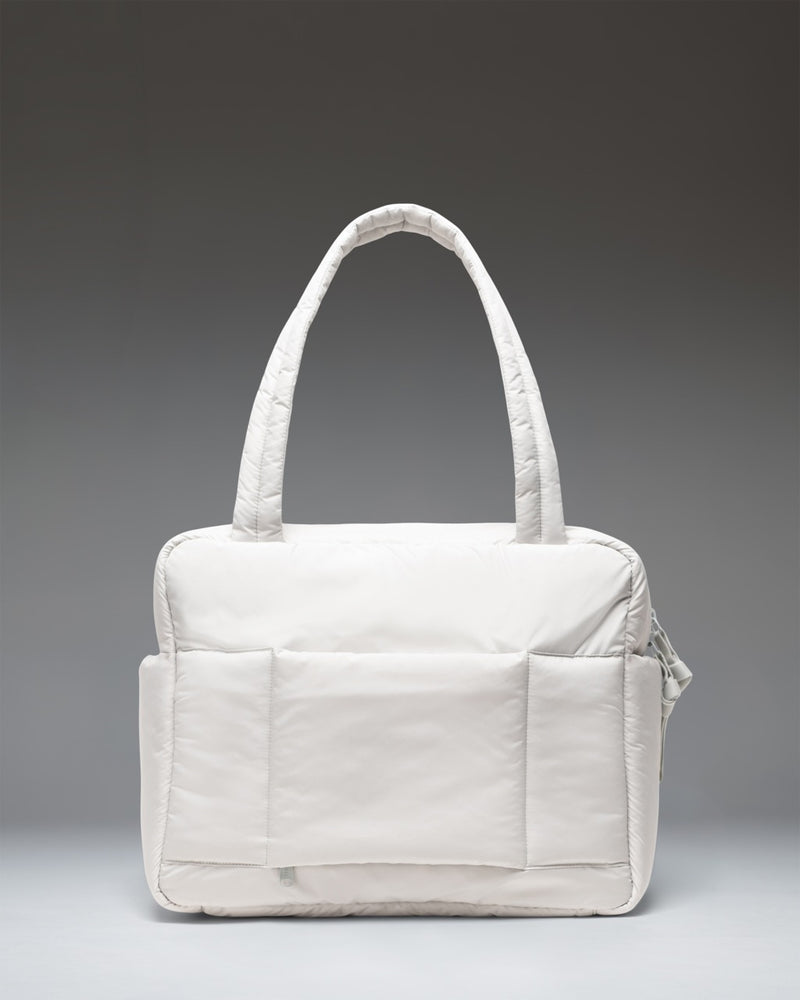 Herschel Supply Co. Cloudform Duffle Bag in Metal gray, showing a clean, minimalist design with dual top handles and a soft, padded fabric structure.
