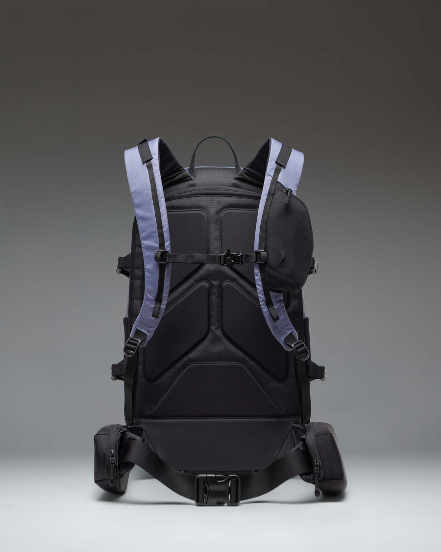 Herschel Supply Co. All Season Pro Backpack 36L in Heron/Black shown from a side angle, highlighting its durable construction and side pockets.