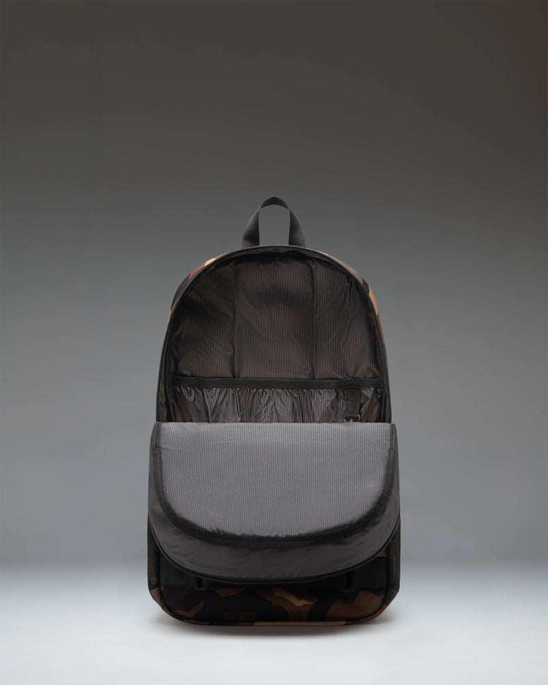 Herschel Supply Co. Fleet Skate Backpack in Woodland Camo/Black, showing the durable exterior design, skateboard straps, and spacious main compartment.