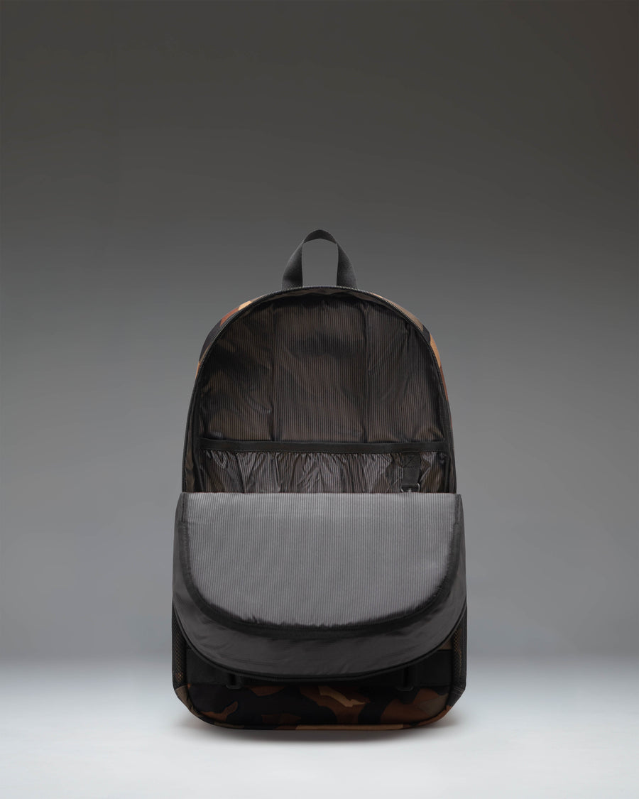 Herschel Supply Co. Fleet Skate Backpack in Woodland Camo/Black, showing the durable exterior design, skateboard straps, and spacious main compartment.