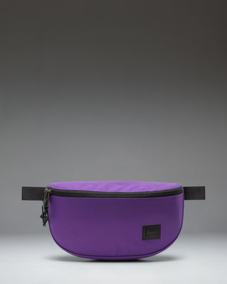 Herschel Supply Co. Kaine Hip Pack in Acai purple, featuring a zippered main compartment, front pocket, and adjustable strap with buckle.