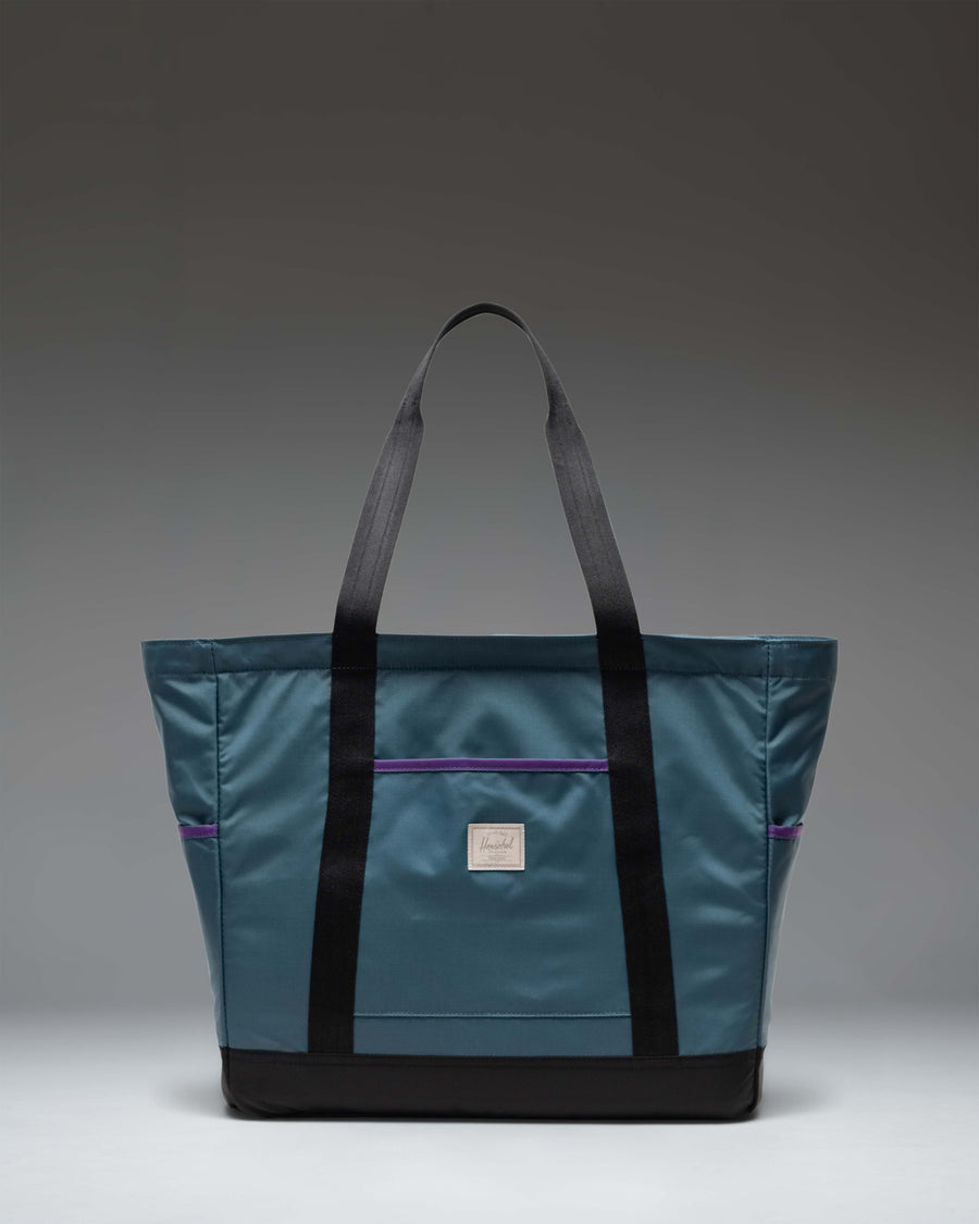 Herschel Supply Co. Heritage Tote bag in Mediterranea blue, featuring a classic rectangular shape and top webbing handles.
