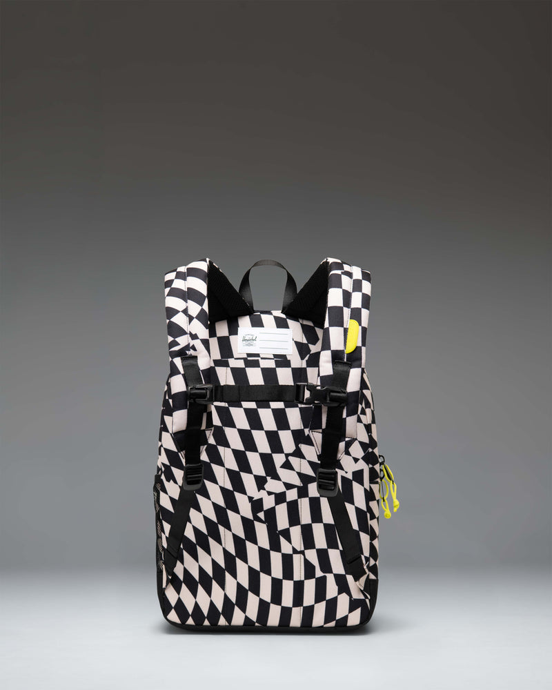 Herschel Supply Co. Herschel Heritage Kids Backpack in Warp Check pattern featuring a black and white checkerboard design with pink accents.