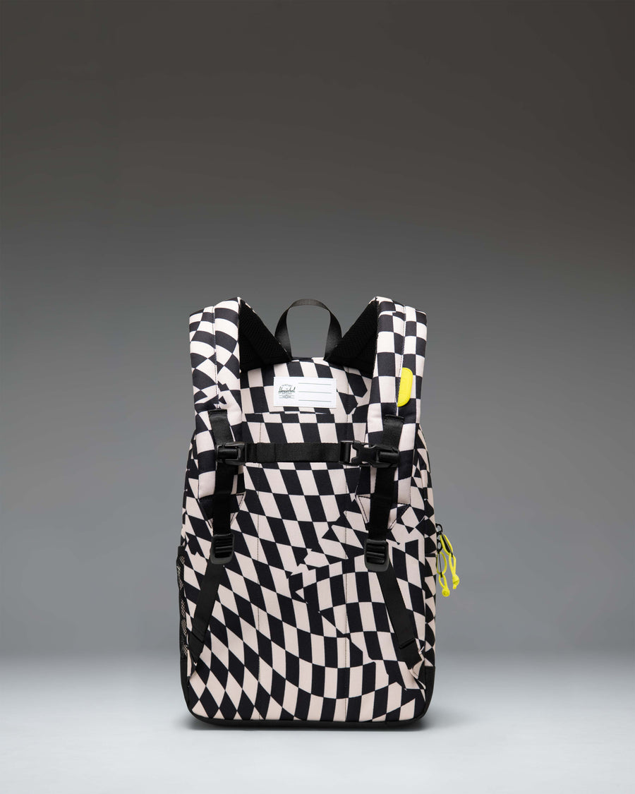 Herschel Supply Co. Herschel Heritage Kids Backpack in Warp Check pattern featuring a black and white checkerboard design with pink accents.
