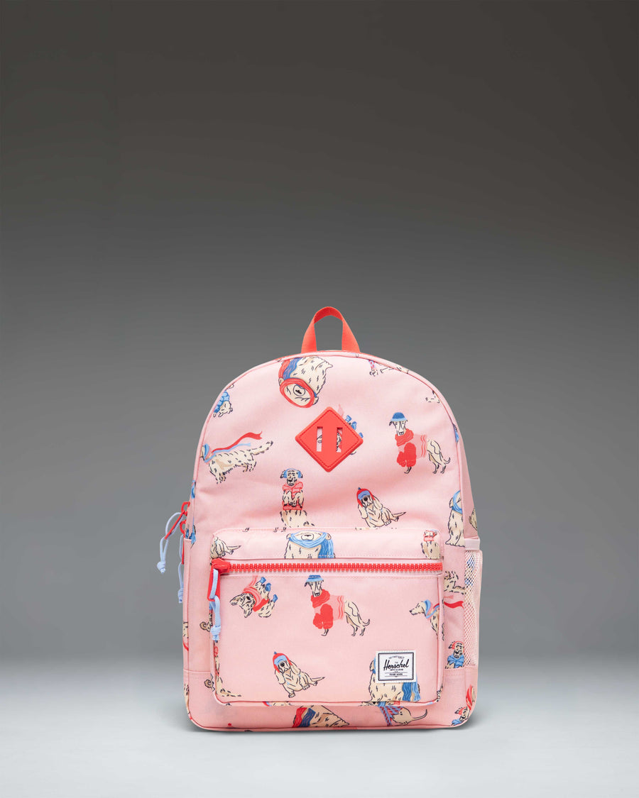 Herschel Heritage Kids Backpack in the Fashion Dogs colorway, featuring a playful print of various illustrated dogs.