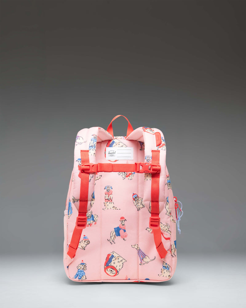 Herschel Heritage Kids Backpack in the Fashion Dogs pattern, featuring an all-over print of various dog breeds on a light-colored background.
