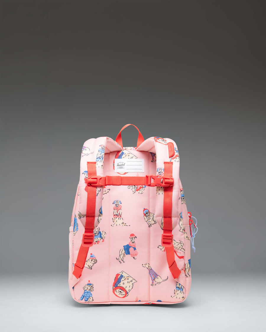 Herschel Heritage Kids Backpack in the Fashion Dogs pattern, featuring an all-over print of various dog breeds on a light-colored background.