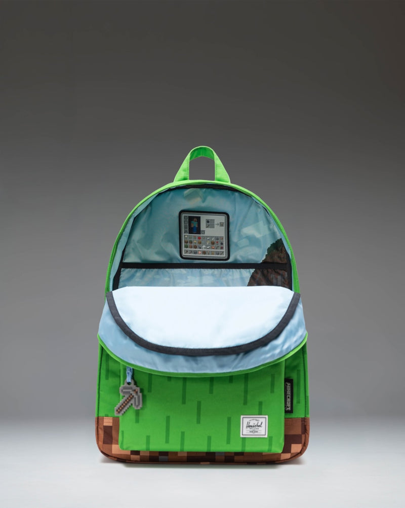 herschel backpack on model forest orange Retreat Supply Co. USA Foldover flap with dual push HERSCHEL SUPPLY CO. The Settlement
