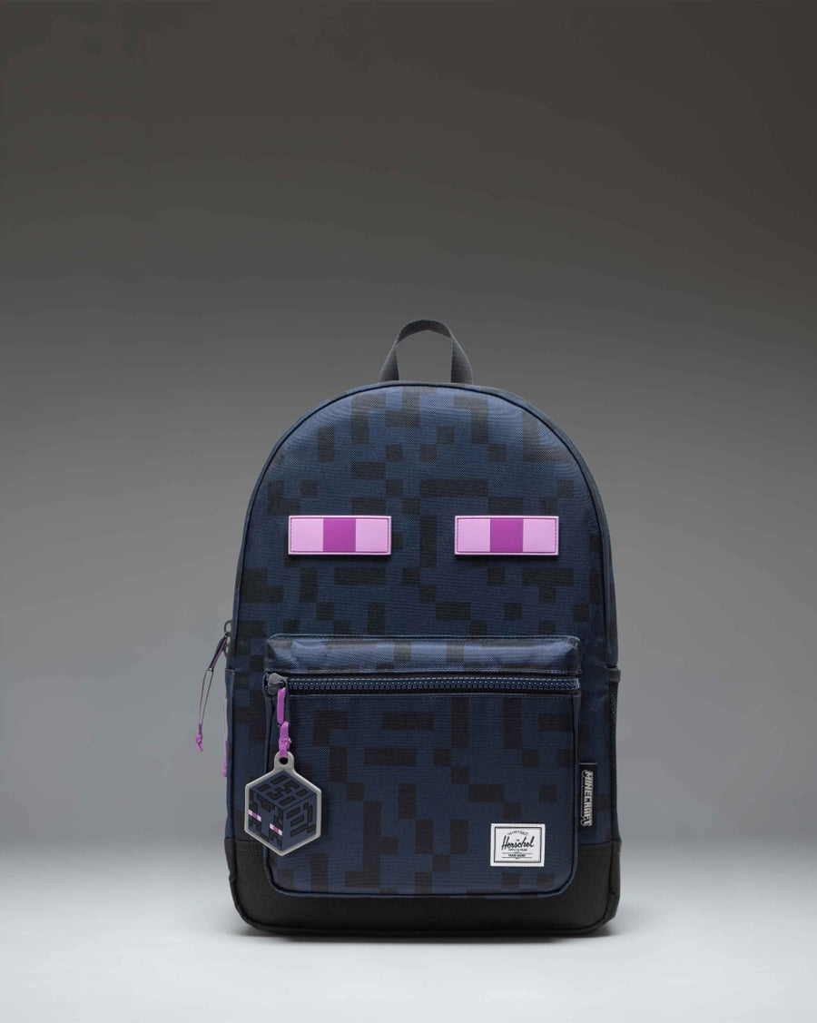 Herschel Supply Co. Minecraft Heritage Youth Backpack in Enderman black and purple with pixelated eye graphics.