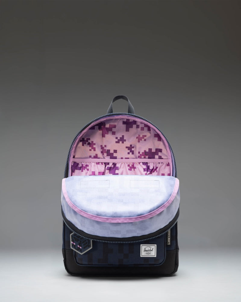 Minecraft Herschel Heritage Youth Backpack in the Enderman colorway featuring a black design with a purple pixelated graphic print.