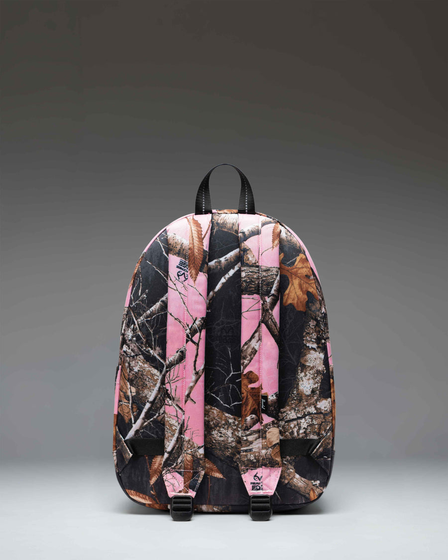 Herschel Classic Backpack in Realtree Edge Camo Pink/Black, featuring a pink and black camouflage pattern with front pocket and shoulder straps.