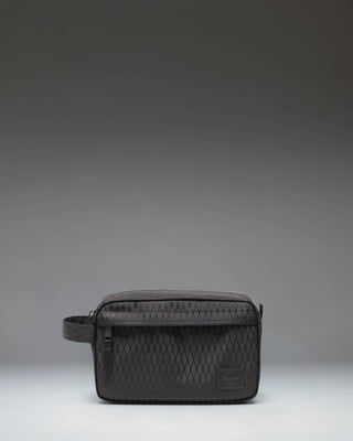 Herschel Supply Co. Chapter Travel Kit in Black Diamond/Black showing a front view of the structured toiletry bag with a carrying handle.