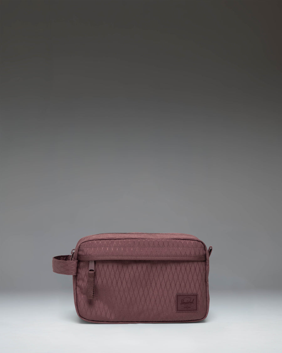 Herschel Supply Co. Chapter Travel Kit toiletry bag featuring the Huckleberry Diamond geometric pattern with a side handle and front pocket.