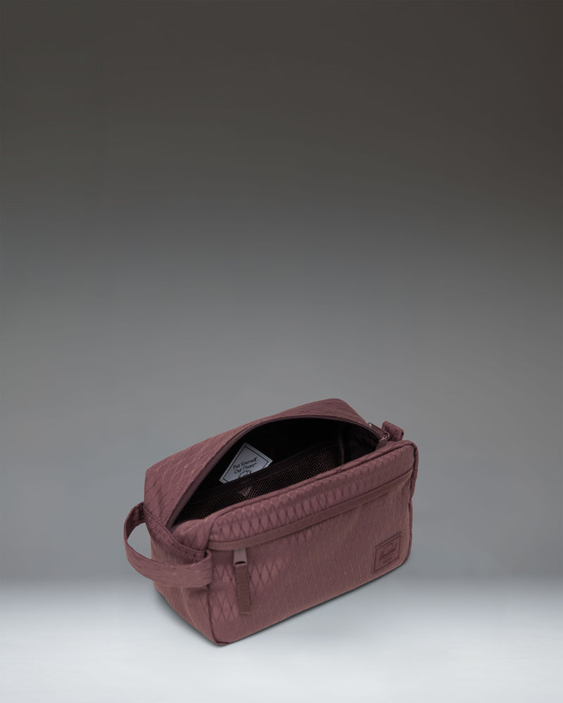 Herschel Supply Co. Chapter Travel Kit in Huckleberry Diamond pattern, showing the side profile and carrying handle.