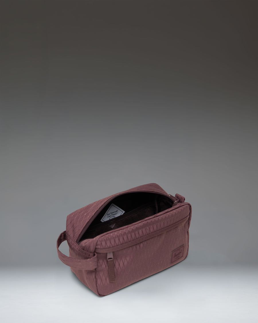 Herschel Supply Co. Chapter Travel Kit in Huckleberry Diamond pattern, showing the side profile and carrying handle.