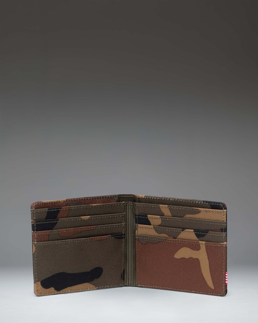 Herschel Supply Co Roy Wallet in Woodland Camo with classic woven black label showing the exterior bi-fold design.