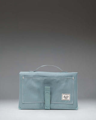 Herschel Sprout Change Mat in a multifold design with storage pockets.