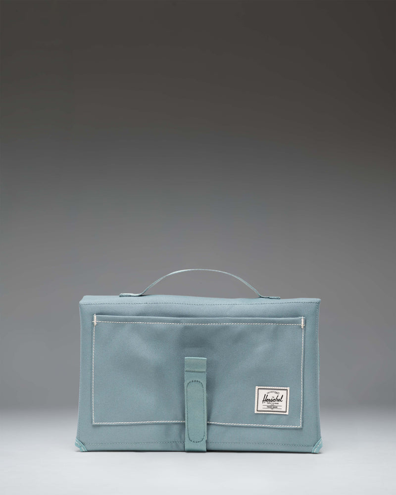 Herschel Sprout Change Mat in a multifold design with storage pockets.