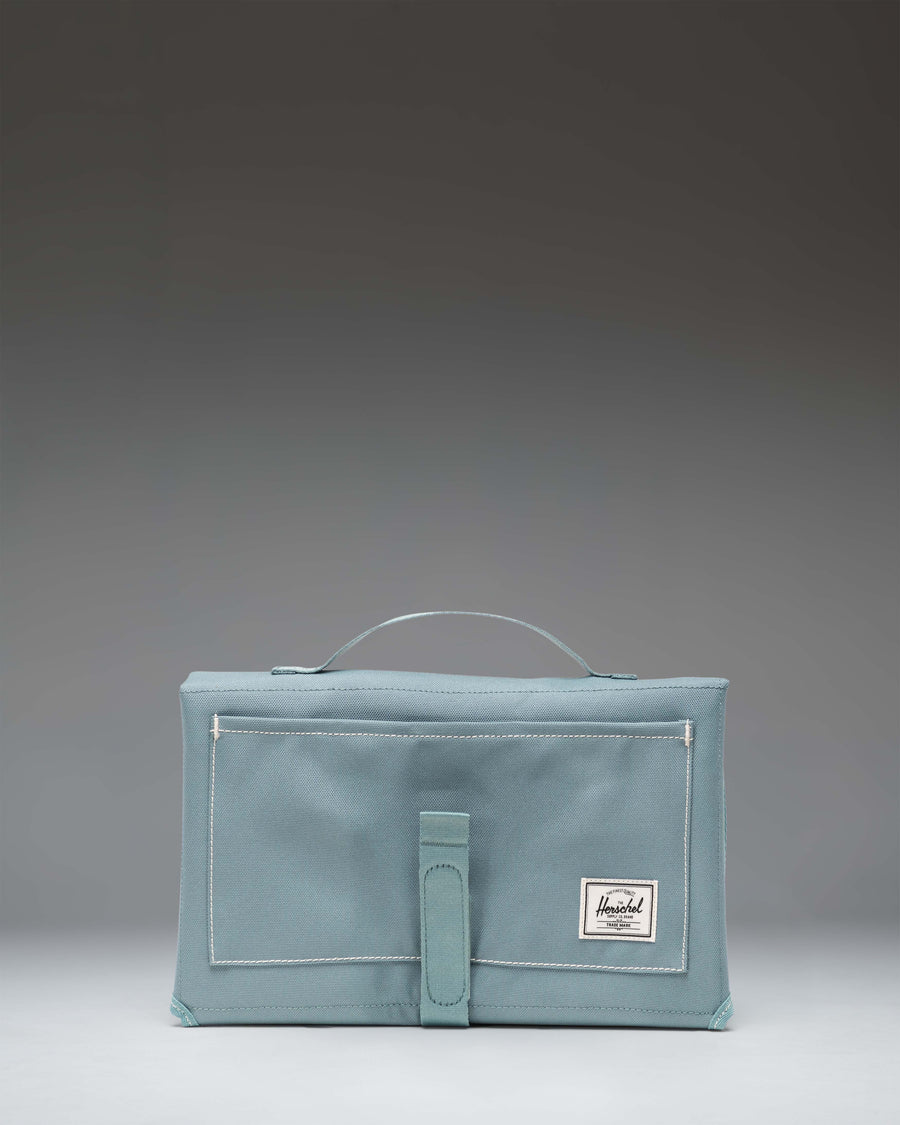 Herschel Sprout Change Mat in a multifold design with storage pockets.